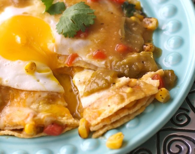 Stacked enchiladas stuffed with cheese and topped with roasted hatch chile sauce