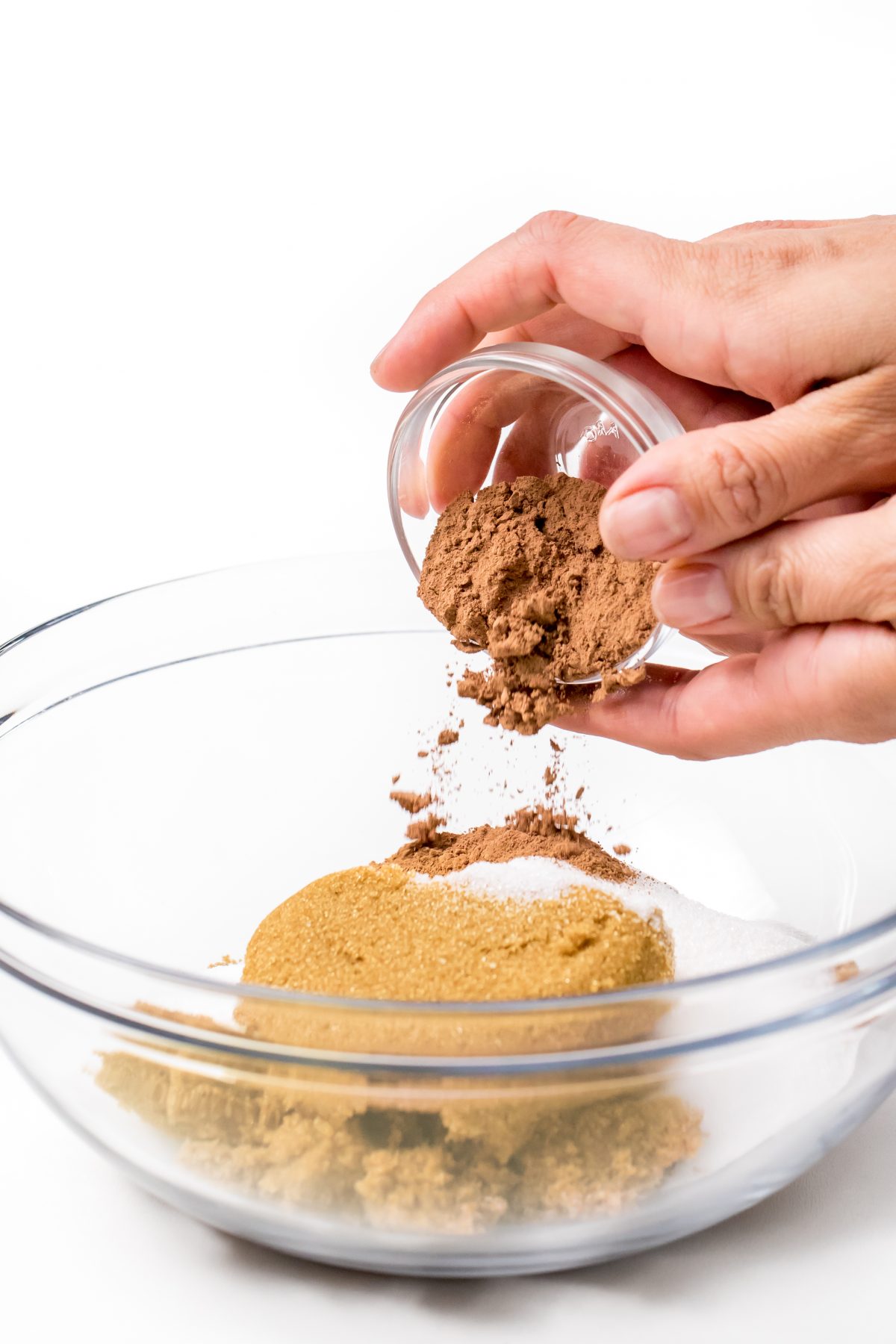 Chocolate sugar scrub - pouring cocoa powder into mixing bowl