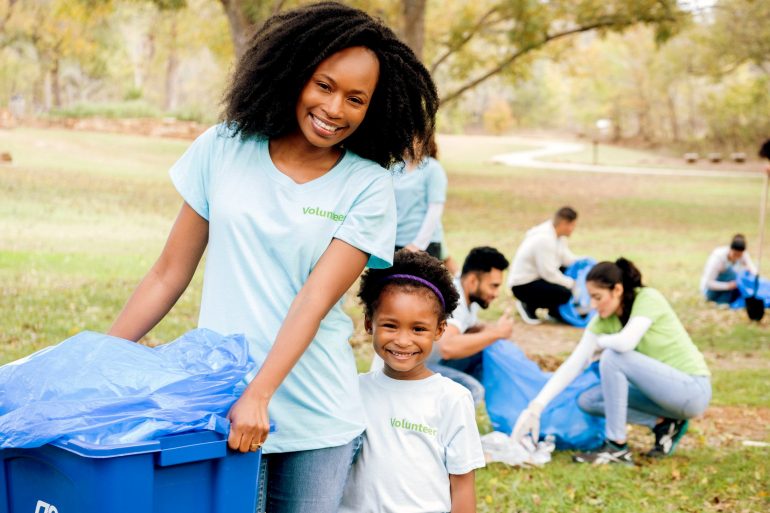 Young girl and her mom help clean up community