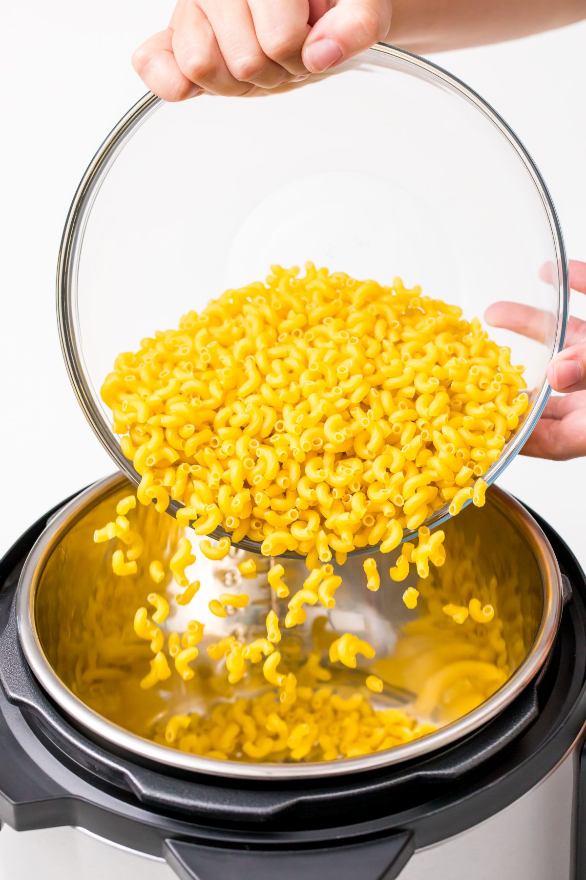 Pour raw macaroni into instant pot