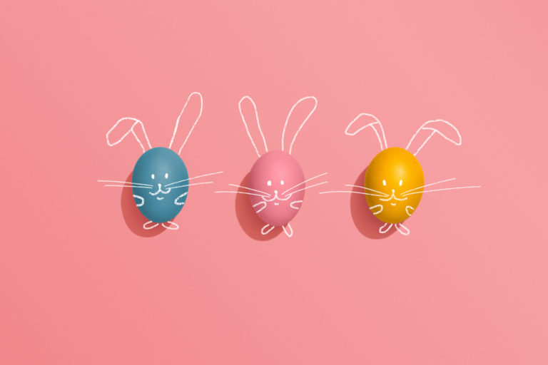 Easter egg rabbits on pink background