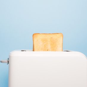 Healthy fashion food of breakfast. Toast in a toaster on a blue background.